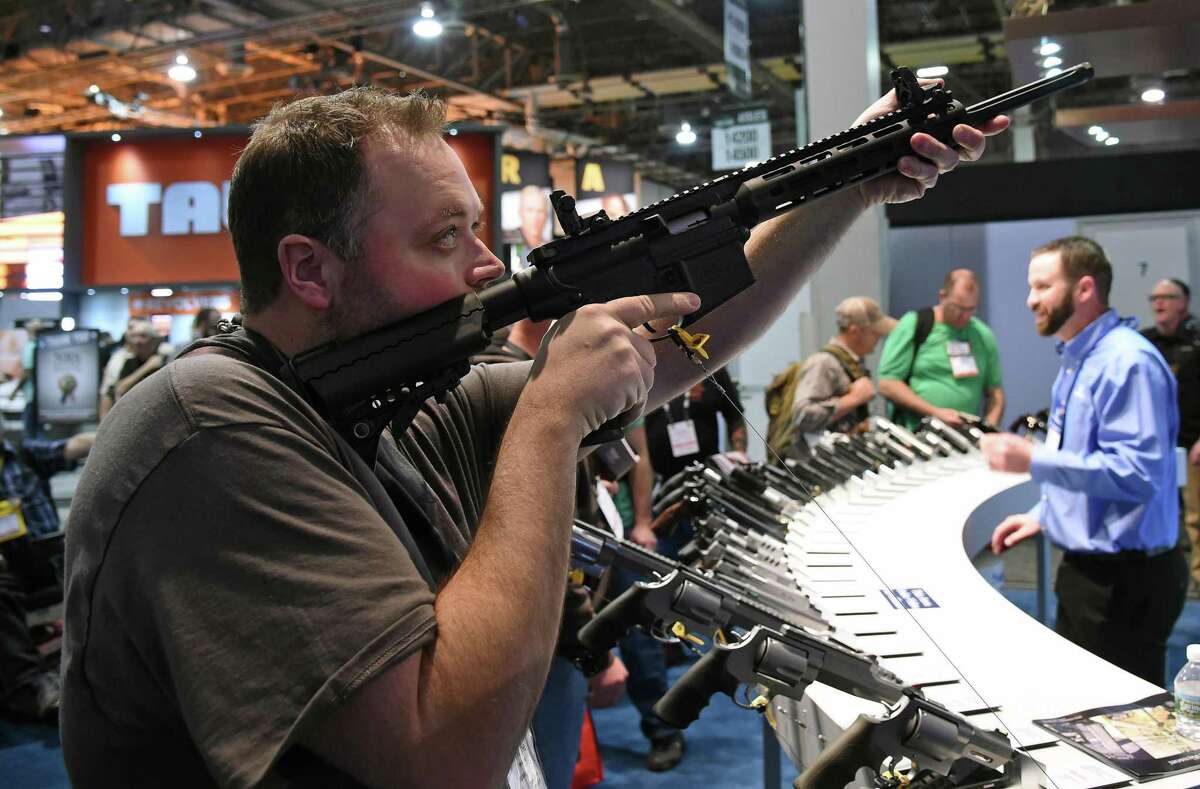 Tyler Burton tries out a sport rifle at the National Shooting Sports Foundation’s SHOT Show at the Sands Expo and Convention Center on January 19, 2016 in Las Vegas, Nevada.