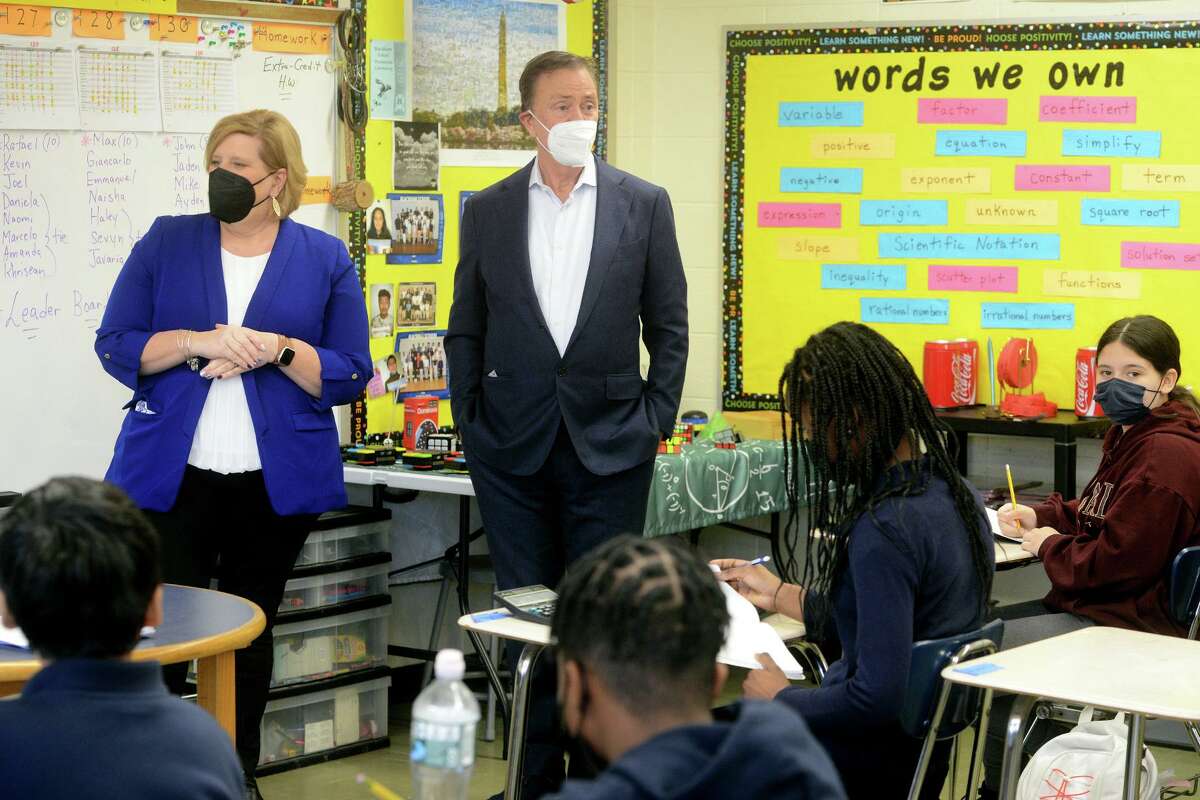 Gov. Ned Lamont speaks to a classroom of eighth graders during a tour of Blackham School, in Bridgeport, Conn. Jan. 24, 2022. Lamont is seen here with Connecticut Education Association (CEA) President Kate Dias.