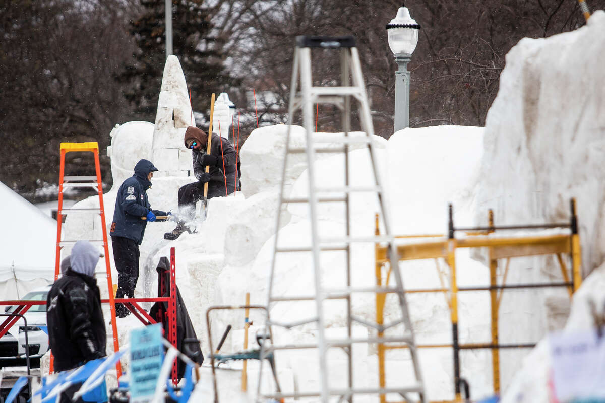 Crowds watch as snow and ice carvers chip away at their creations during the Zehnder's Snowfest Thursday, Jan. 27, 2022 in Frankenmuth.