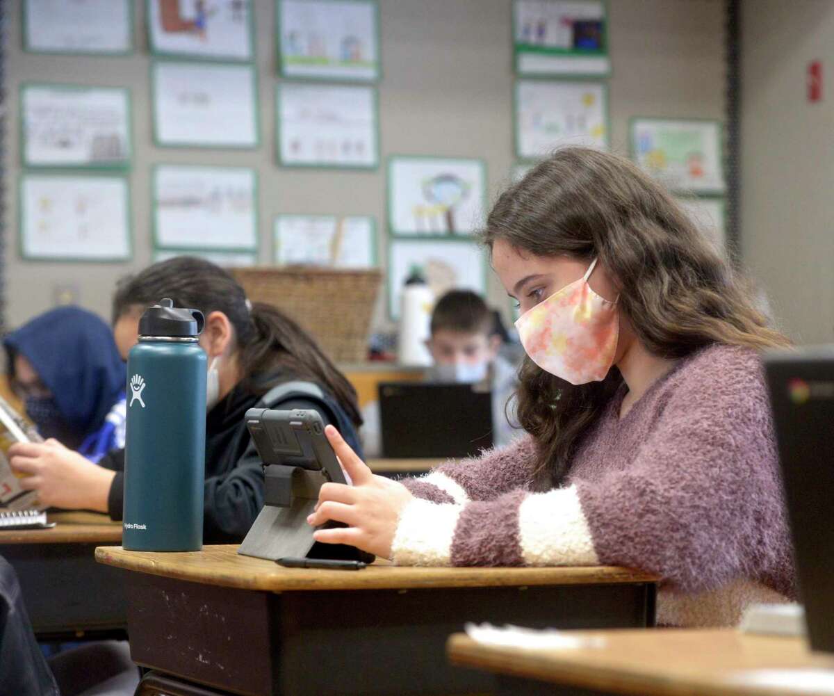 Julie Mendes, age 11, of Danbury, studies during her sixth grade science class at St Joseph School on Friday, February 5, 2021, in Danbury, Conn. The school is launching a “kindness” campaign to raise money for the school and local organizations.