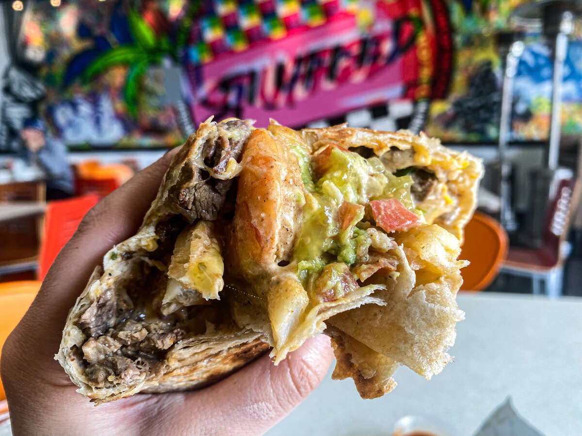 The Surf and Turf burrito from Stuffed comes with carne asada, fries, sour cream, pico de gallo, cheese, and guacamole. 