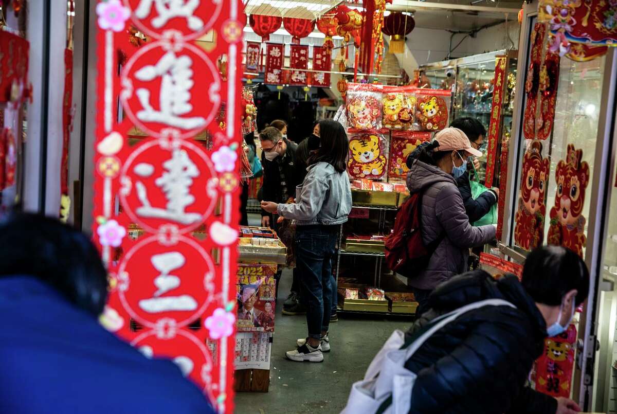 Customers shop inside Buddha Exquisite ahead of the annual Lunar New Year celebration in Chinatown.