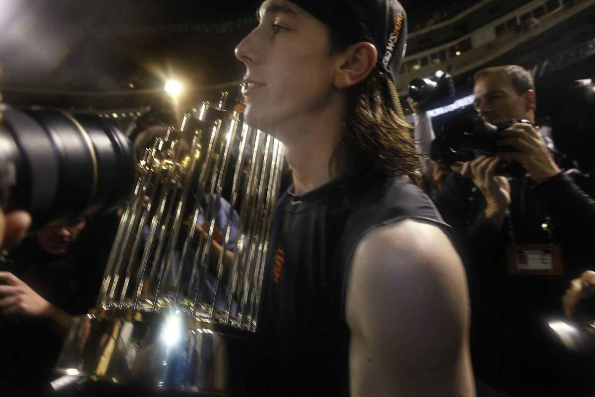 San Francisco Giants starting pitcher Tim Lincecum (55) carries the 2010 World Series Championship trophy on the field at Rangers Ballpark after the San Francisco Giants win Game 5 of the World Series over the Texas Rangers 3-1 on Monday November 1, 2010 in Arlington, Texas.