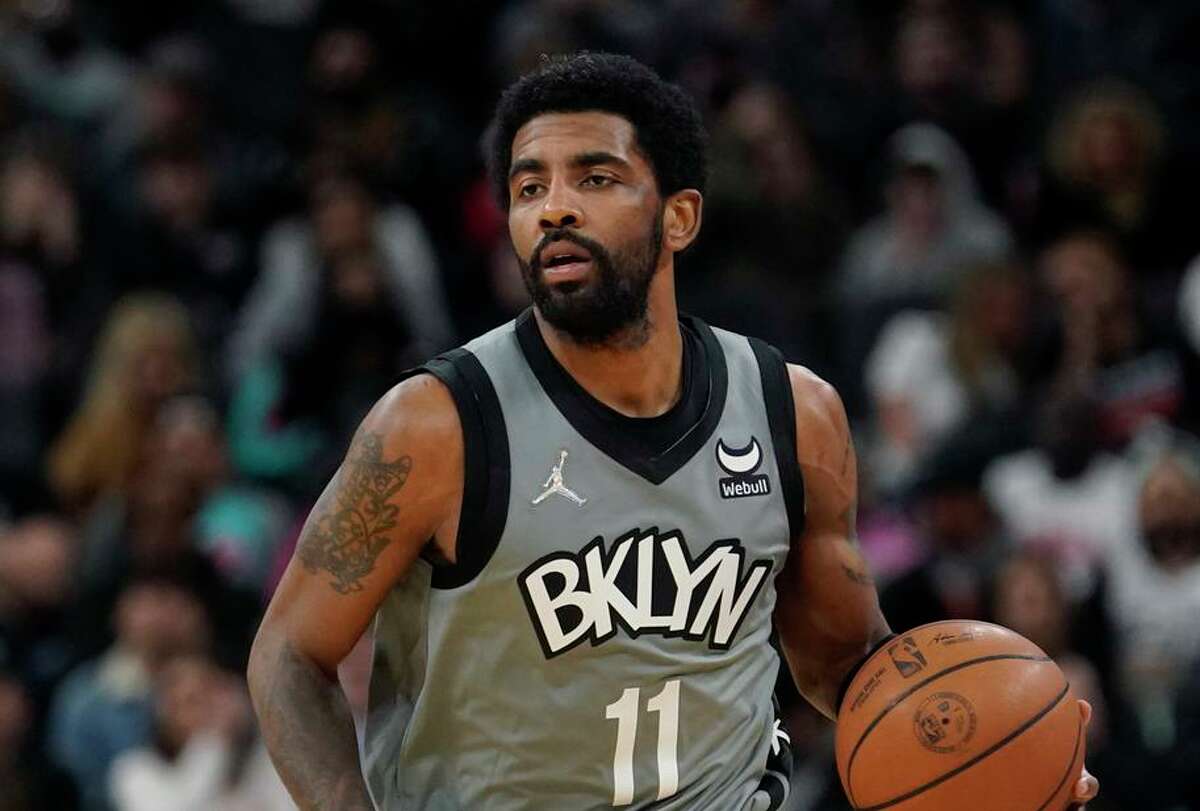 Brooklyn Nets guard Kyrie Irving handles the ball during the first half of a game in San Antonio on Jan. 21. Irving and the Nets make their only visit of the season to San Francisco on Saturday.