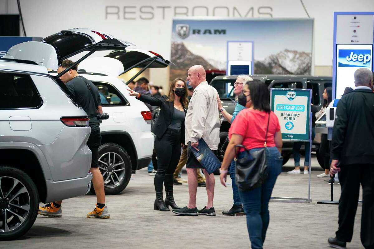 People walk through the Jeep display at the 2022 combined Houston Boat Show and Houston Auto Show, Thursday, Jan. 27, 2022, at NRG Center.