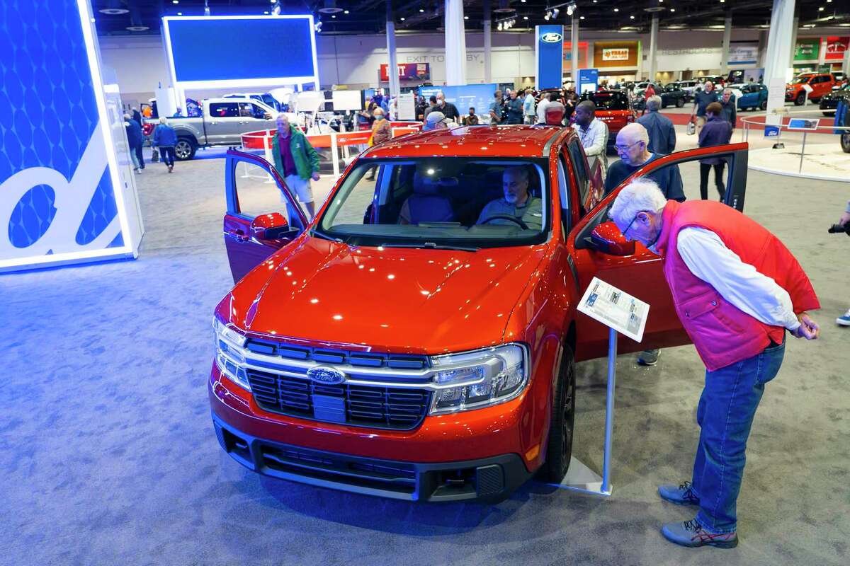 People look at the new Ford Maverick pickup truck at the 2022 combined Houston Boat Show and Houston Auto Show, Thursday, Jan. 27, 2022, at NRG Center.