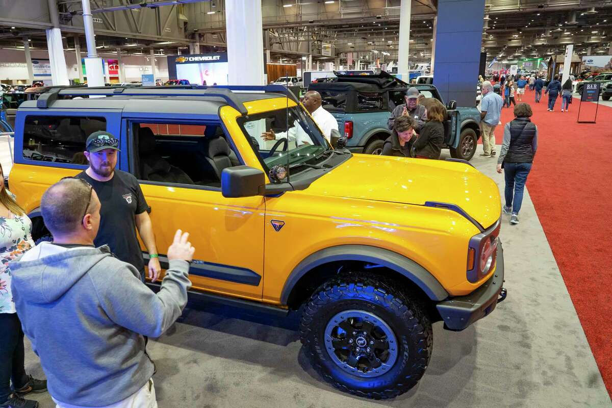 People look at a new Bronco at the 2022 combined Houston Boat Show and Houston Auto Show, Thursday, Jan. 27, 2022, at NRG Center.