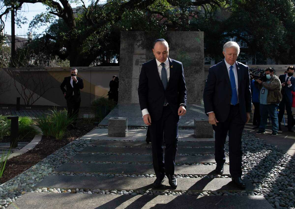 The Ambassador of Romania to the United States, H. E. Andrei Muraru, and U.S. Rep. Randy Weber walk away after placing stones, which serve as tokens of respect, at the Eric Alexander Memorial for International Holocaust Remembrance Day on Thursday, Jan. 27, 2022, at Holocaust Museum Houston. This day of remembrance is commemorated across the world in honor of the six million Jews murdered during the Holocaust.