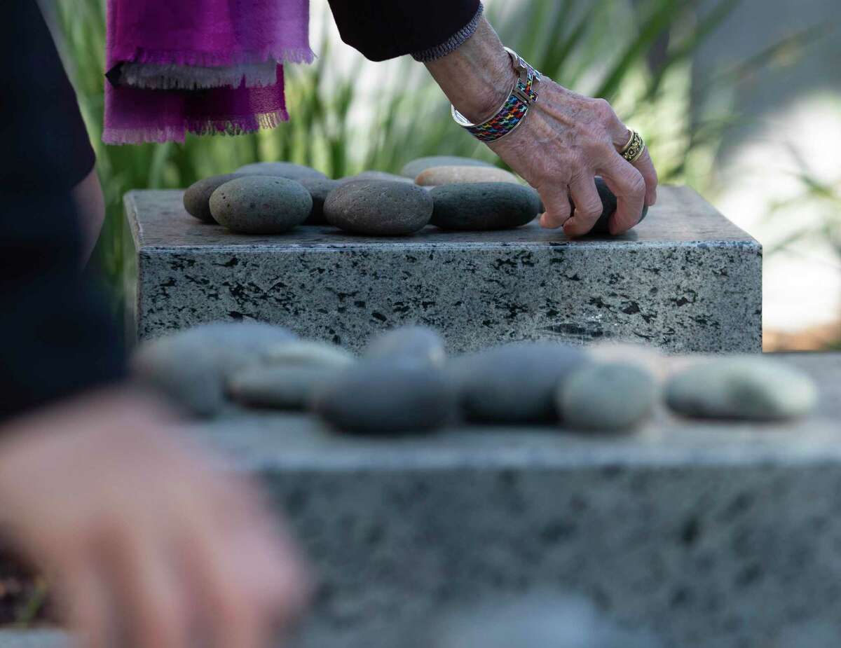 People place stones to pay their respects at the Eric Alexander Memorial in observance of International Holocaust Remembrance Day on Thursday, Jan. 27, 2022, at Holocaust Museum Houston. This day of remembrance is commemorated across the world in honor of the six million Jews murdered during the Holocaust.