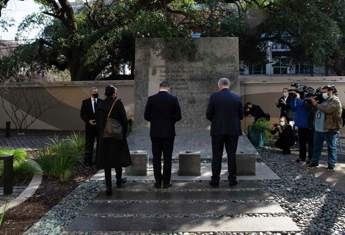 Consul General of France in Houston Valérie Baraban, from left, Ambassador of Romania to the United States H. E. Andrei Muraru and U.S. Rep. Randy Weber place stones at the Eric Alexander Memorial for International Holocaust Remembrance Day on Thursday, Jan. 27, 2022, at Holocaust Museum Houston in Houston. This day of remembrance is commemorated across the world in honor of the six million Jews murdered during the Holocaust.
