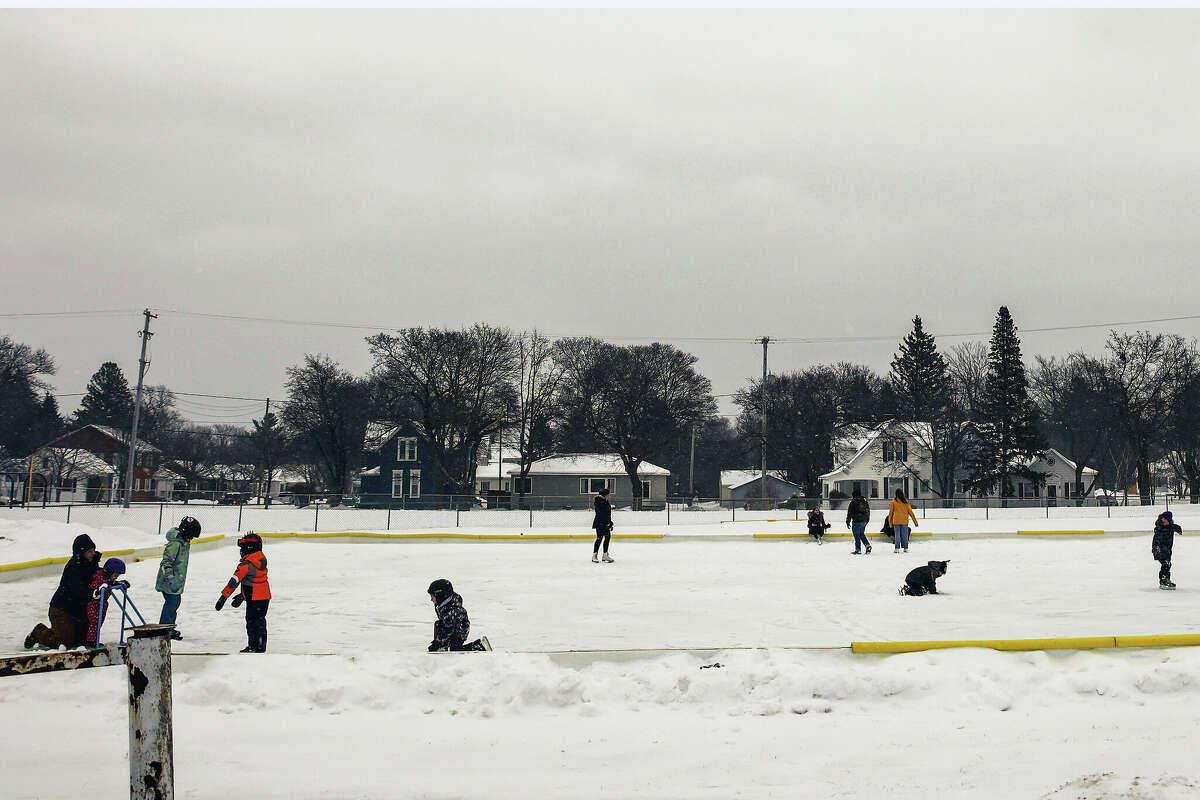 Children, teens and adults skate at the Sands Park ice skating rink Thursday afternoon in Manistee. 