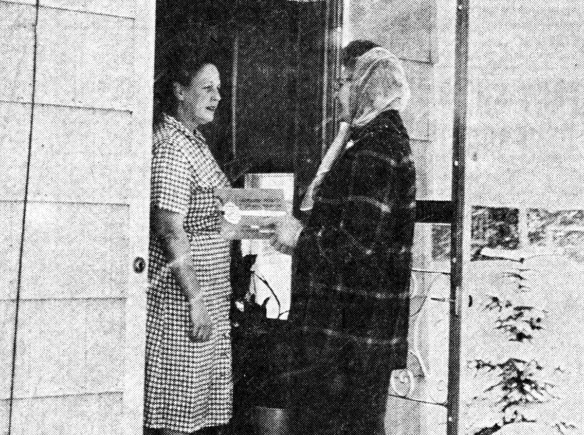 This scene will likely be duplicated many times tonight when the Mother's March for the March of Dimes campaign gets underway at 6 p.m. A preview of the important part of the campaign is shown above as Mrs. Marshall Christianson, Parkdale captain, contacts Mrs. Tom Markham. The photo was published in the News Advocate on Jan. 29, 1962.