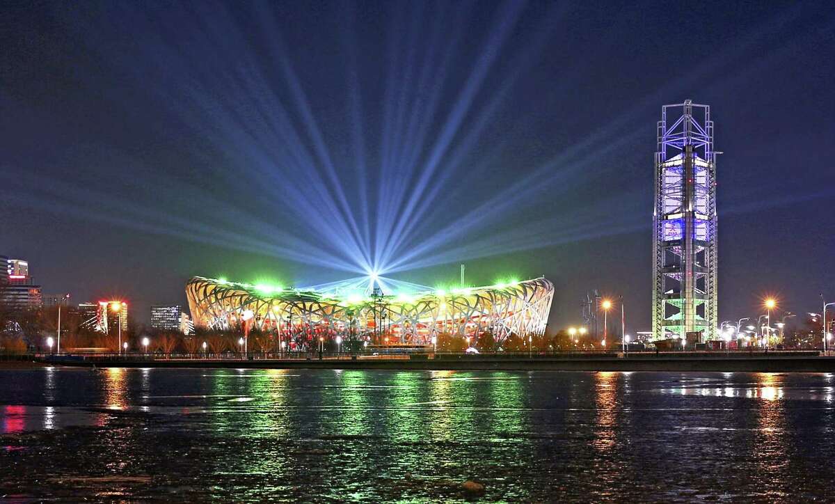 Lights abeam from the National Stadium in Beijing during a rehearsal for the 2022 Winter Olympics opening ceremony on Thursday evening.