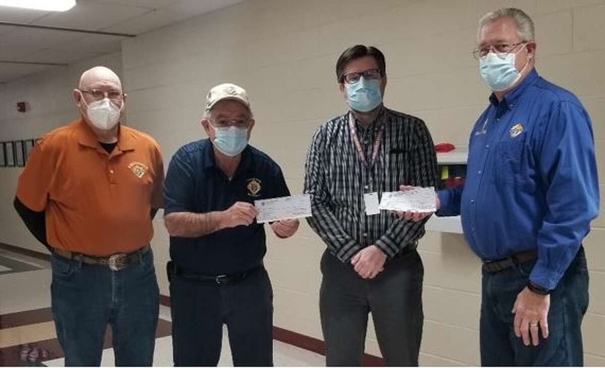 Bethalto Knights of Columbus members Jim Albarado, Leo Mushill and Marce Tebbe present a donation to the Bethalto Community Unit School District #8 for Special Education.