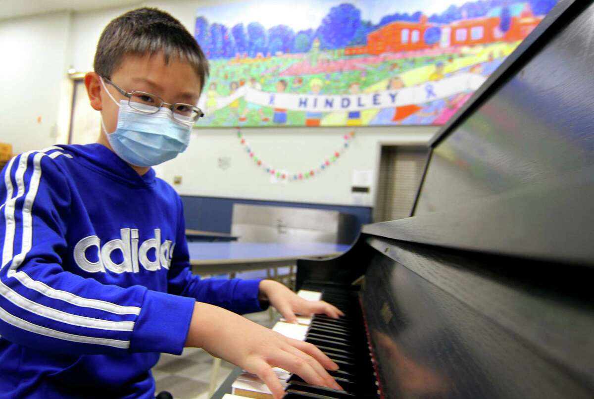 Hindley School fourth-grader Christopher Li, who has won an international piano competition, poses at the school in Darien, Conn., on Tuesday January 25, 2022.
