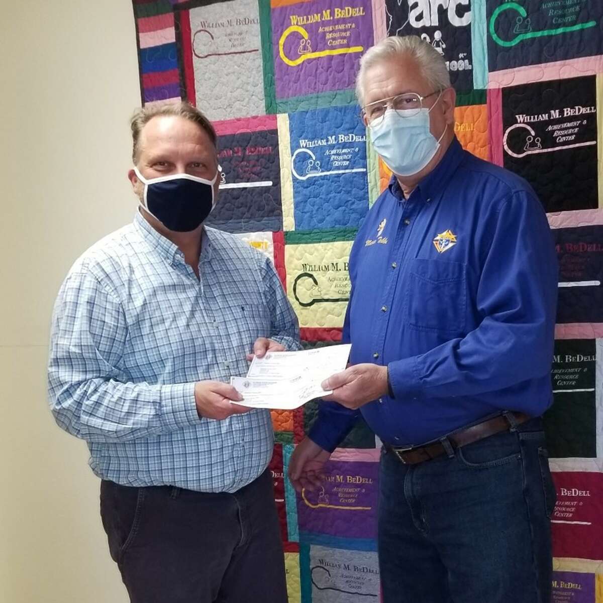 Bethalto Knights of Columbus member Marce Tebbe presents a donation to the Madison County Achievement & Resource Center in Wood River.