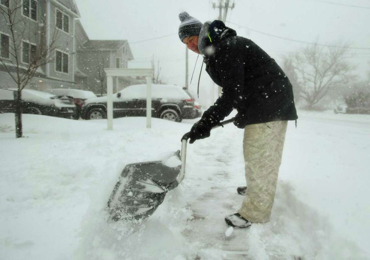 Topher Scheel gets a head start shovelling snow during the height of the blizzard in front of his home on Reef Road in Fairfield, Conn. on Monday, February 1, 2021.