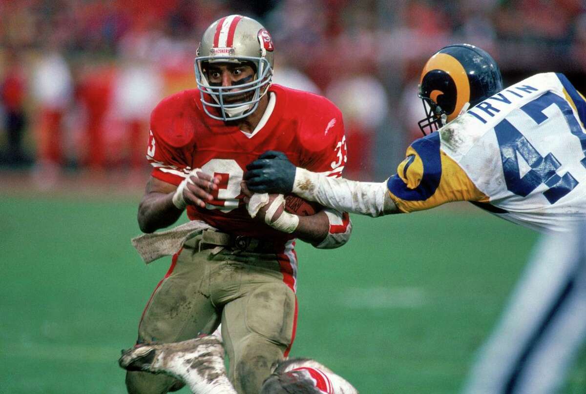 San Francisco running back Roger Craig tries to break away from Rams cornerback LeRoy Irvin during the title game at Candlestick Park.
