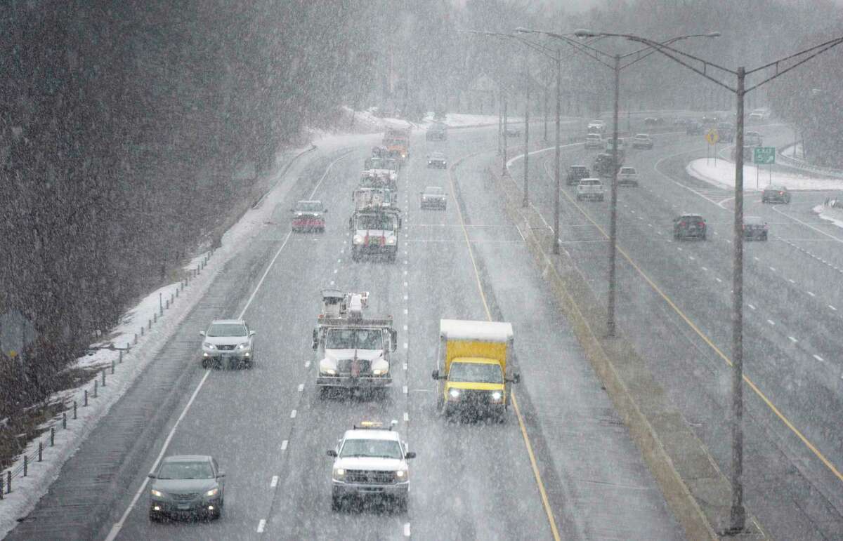 Snow falls on eastbound traffic on I-84, mid-day Friday, January 28, 2022, Danbury, Conn.