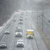 Snow falls on eastbound traffic on I-84, mid-day Friday, January 28, 2022, Danbury, Conn.