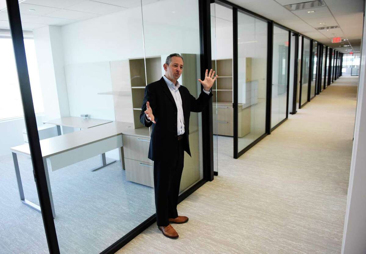 Litigation department partner Robert Hoff shows the row of attorneys' offices in the new Wiggin and Dana offices on the 14th floor of 281 Tresser Blvd., at 2 Stamford Plaza, in downtown Stamford, Conn., on Tuesday, Jan. 18, 2022.