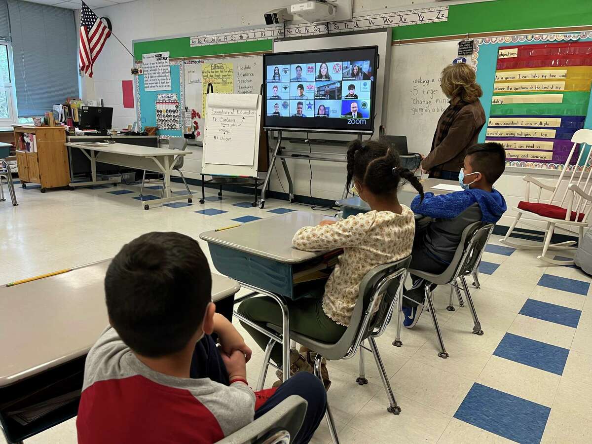Third-grade teacher Teresa Scatamacchia watches the livestream with U.S. Secretary of Education Miguel Cardona along with her students on Friday, Jan. 28, 2022.