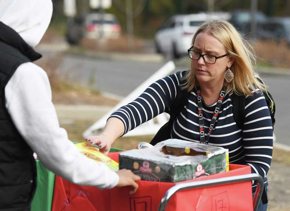 Kathleen Mendez, adviser for the Greenwich High Roots & Shoots Club, helps students organize food items donated for residents in need on Nov. 25, 2019. The GHS Roots & Shoots Club ran the Thanksgiving Food Drive, with students and faculty donating all the items. As a result, 85 families received a box filled with all the essentials for a Thanksgiving meal.
