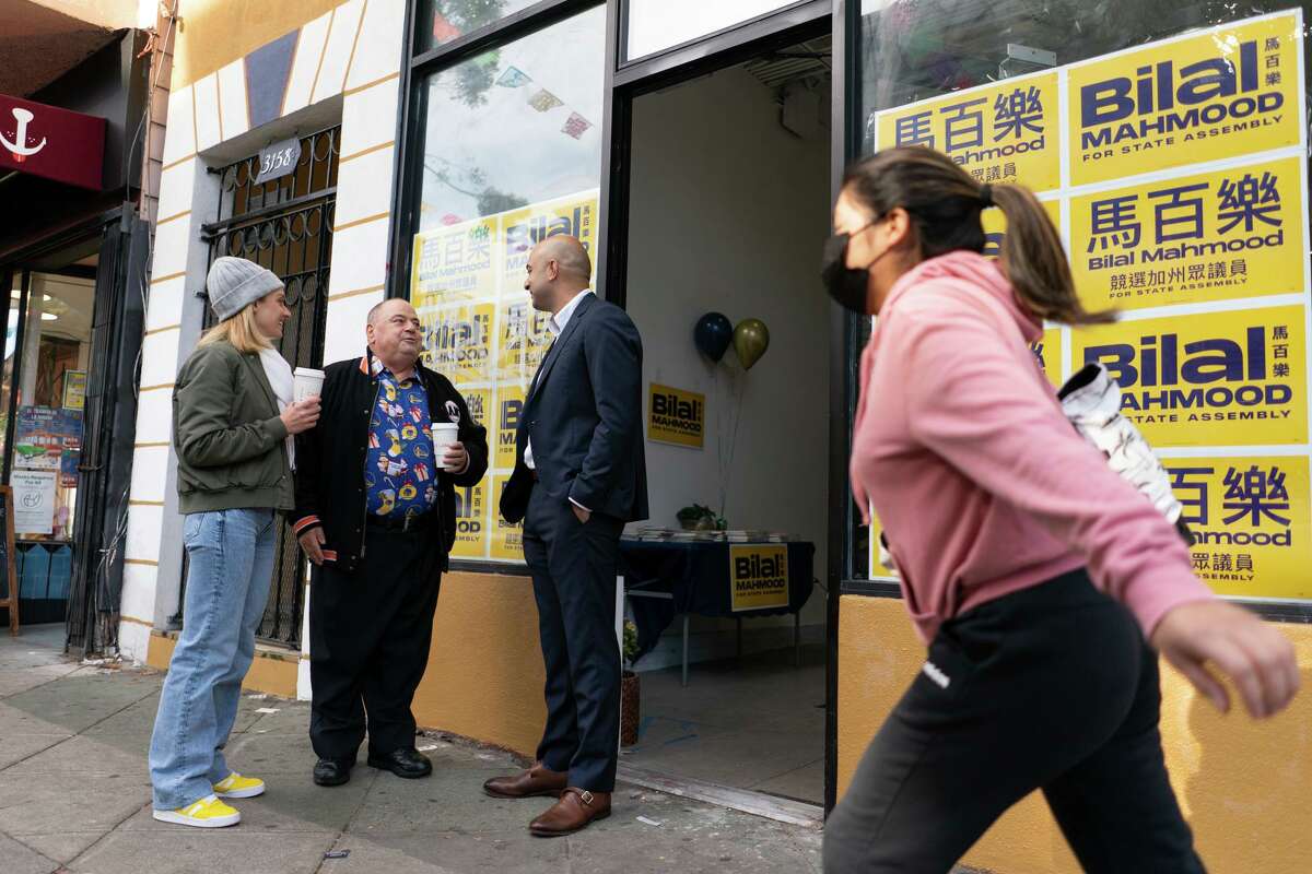 Assembly candidate Bilal Mahmood (right) chats with Scotty Todd and Hilary Shirazi at Mahmood’s campaign headquarters in San Francisco.