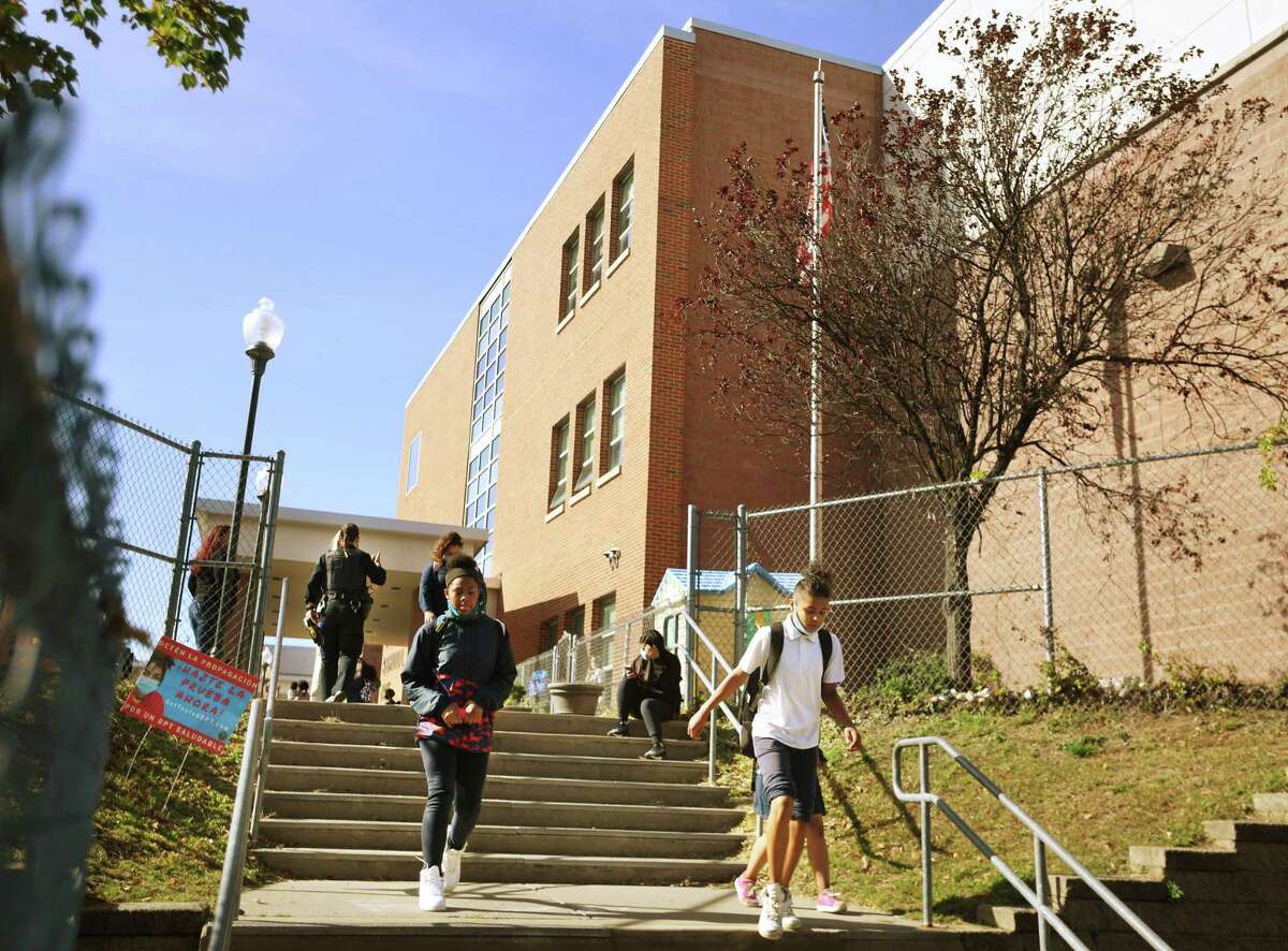 Students head home at the end of the school day outside Barnum School in Bridgeport, Conn. on Thursday, October 15, 2020.