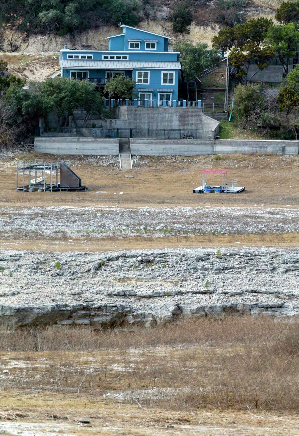A normally lakeside home stands far from the water in the Lakehills area of Medina Lake on Jan. 21.