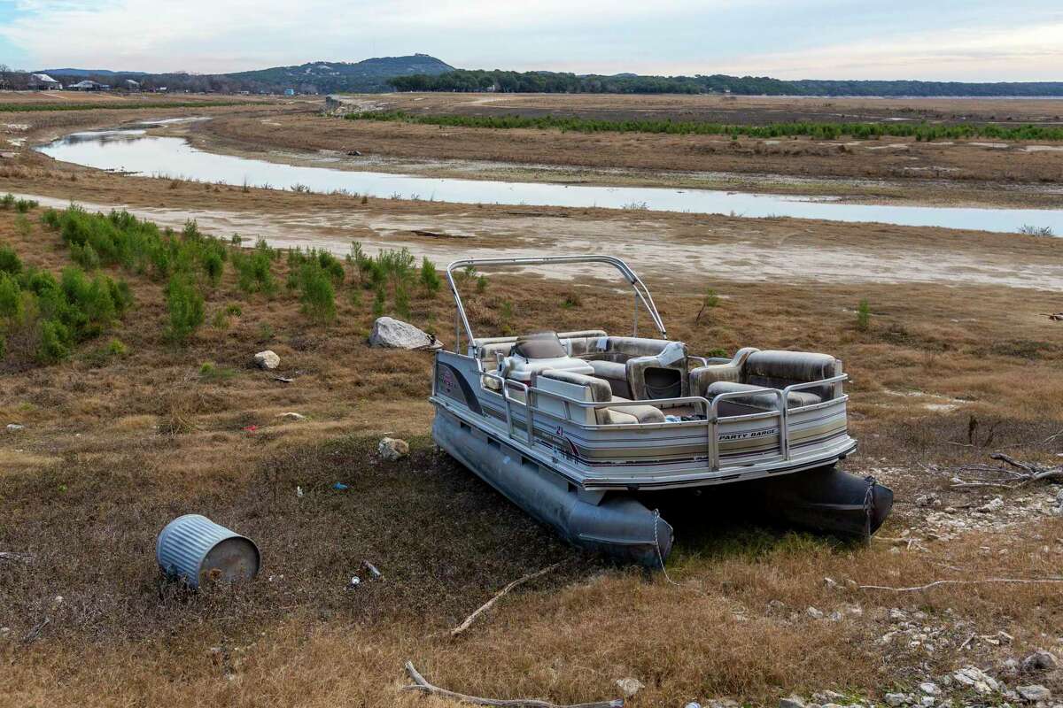 A pontoon boat sits far from the water in Medina Lake on Jan. 12.