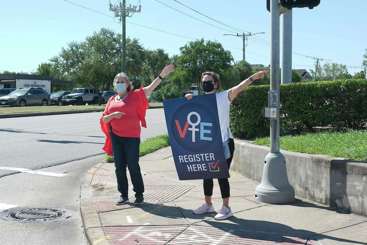 Nancy Steger and Linda Berlinger direct people to the Harris County Freeman Library in Clear Lake where League of Women Voters volunteers assisted volunteers with voter registration in September 2020.