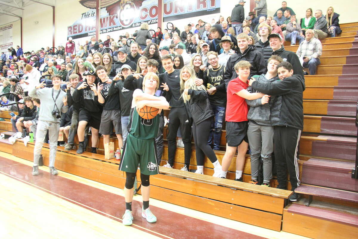 The Laker Student Section, and Logan Carr, cheer on the Lakers.