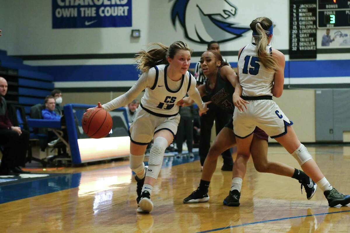 Clear Springs’ Kenna Gibson (13) drives to the basket past Clear Creek’s Kirsten Lockett-Bell (4) Friday at Clear Springs High School.