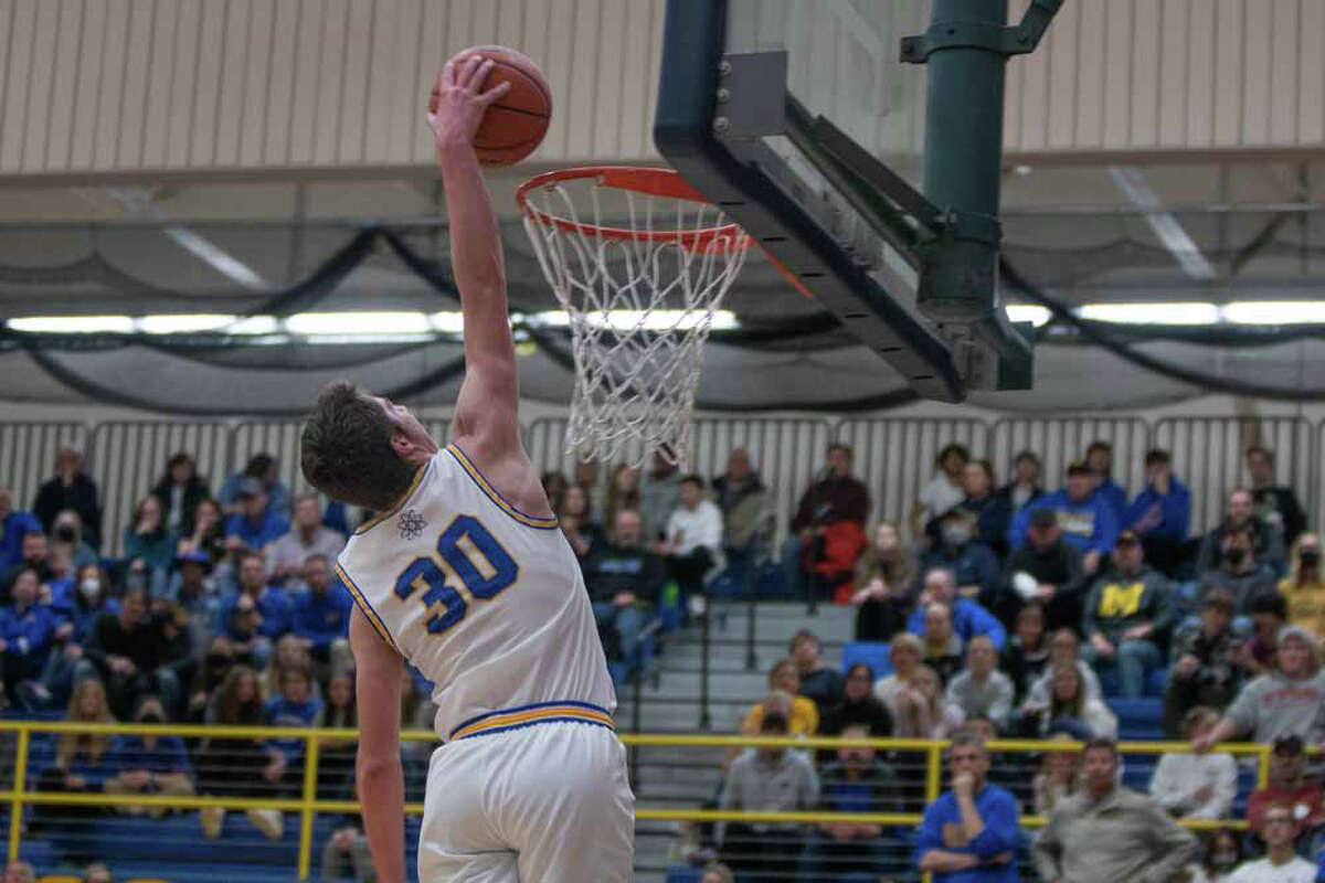 Midland High School's Drew Barrie dunks the ball during a varsity boys basketball game against Dow High School on Jan. 28 in Midland, Mich. The Chemics won 65-39.