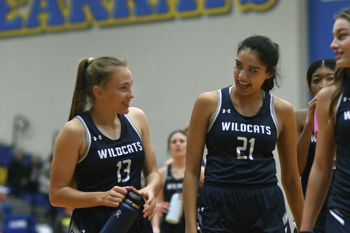 Tomball Memorial sophomore guard Brianna Carrigan (13) and senior forward Samantha Diaz (21) are all smiles during a timeout in the 4th quarter of their District 15-6A matchup at Klein High School on Jan. 26, 2022.