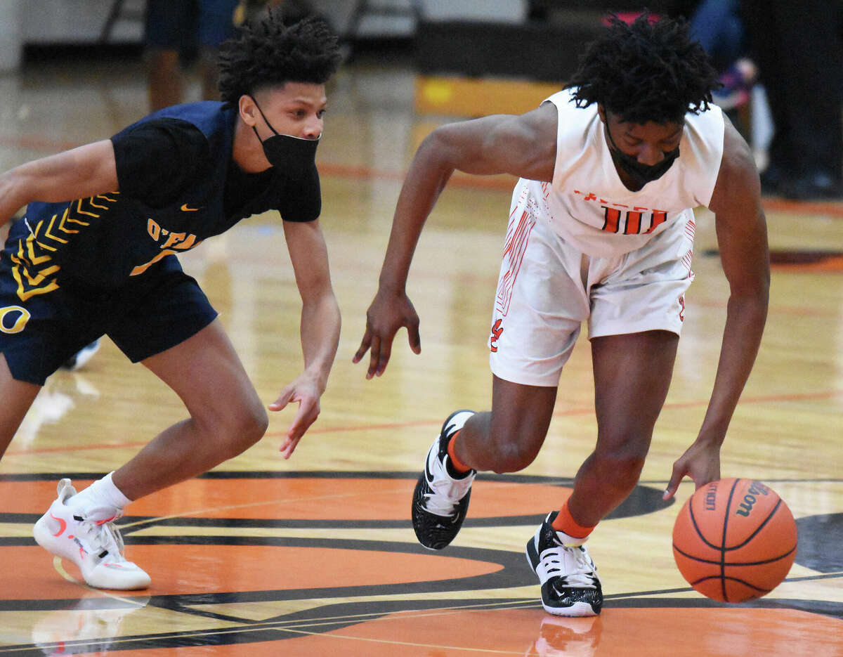 Edwardsville's Johnnie Robinson, right, comes away with a steal during the fourth quarter against the O'Fallon Panthers on Friday inside Lucco-Jackson Gymnasium in Edwardsville.