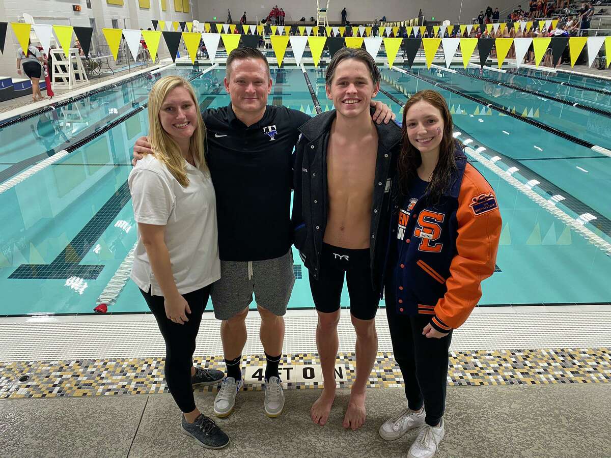 District 19-6A swimming and diving award winners included (from left) Tompkins coach Kate Sweeso, Taylor coach Matt Apple, Taylor swimmer Logan Pack and Seven Lakes swimmer Taylor Craft.