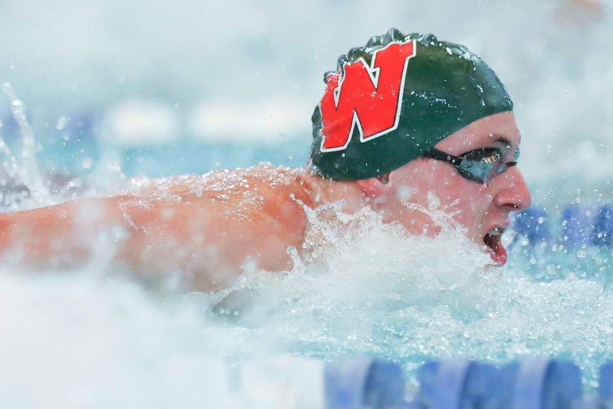 Slade Stephens of The Woodlands competes in the boys 100-yard butterfly during the District 13-6A swimming and diving championship at the Conroe ISD Natatorium, Saturday, Jan. 22, 2022, in Shenandoah.