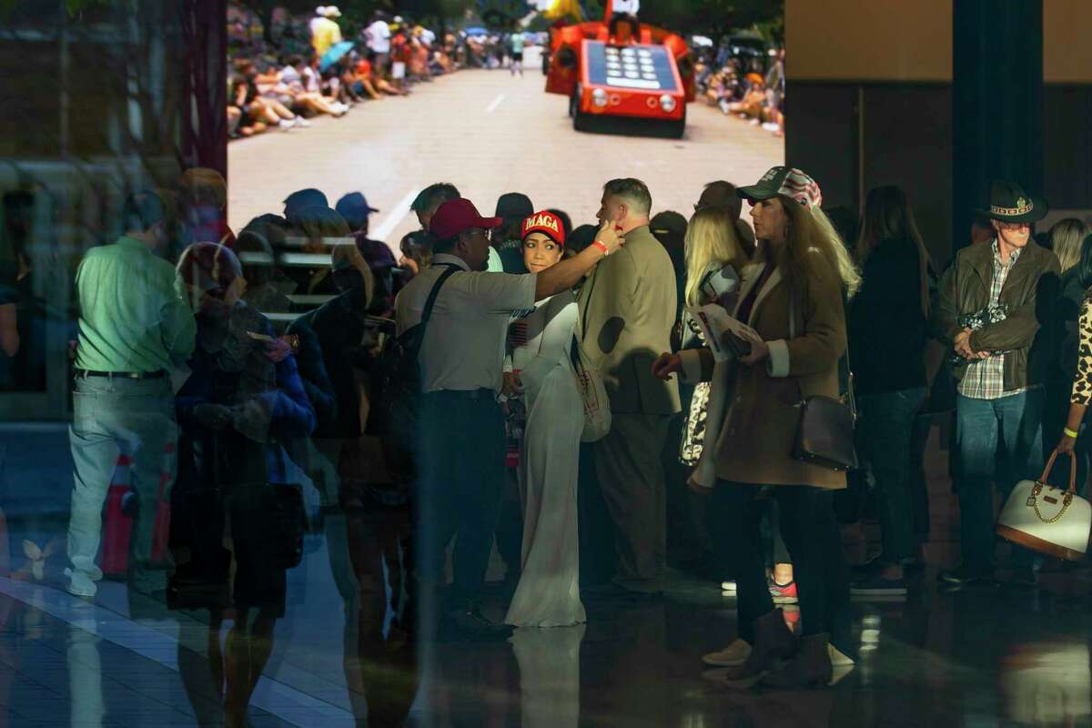 People line up to enter the American Freedom Tour event, Saturday, Jan. 29, 2022, at the George R. Brown Convention Center in Houston. The event precedes a campaign-style rally by the former president in Conroe Saturday evening and features a slate of speakers including former president Donald Trump, his son Donald Trump, Jr., and former Fox News host Kimberly Guilfoyle.