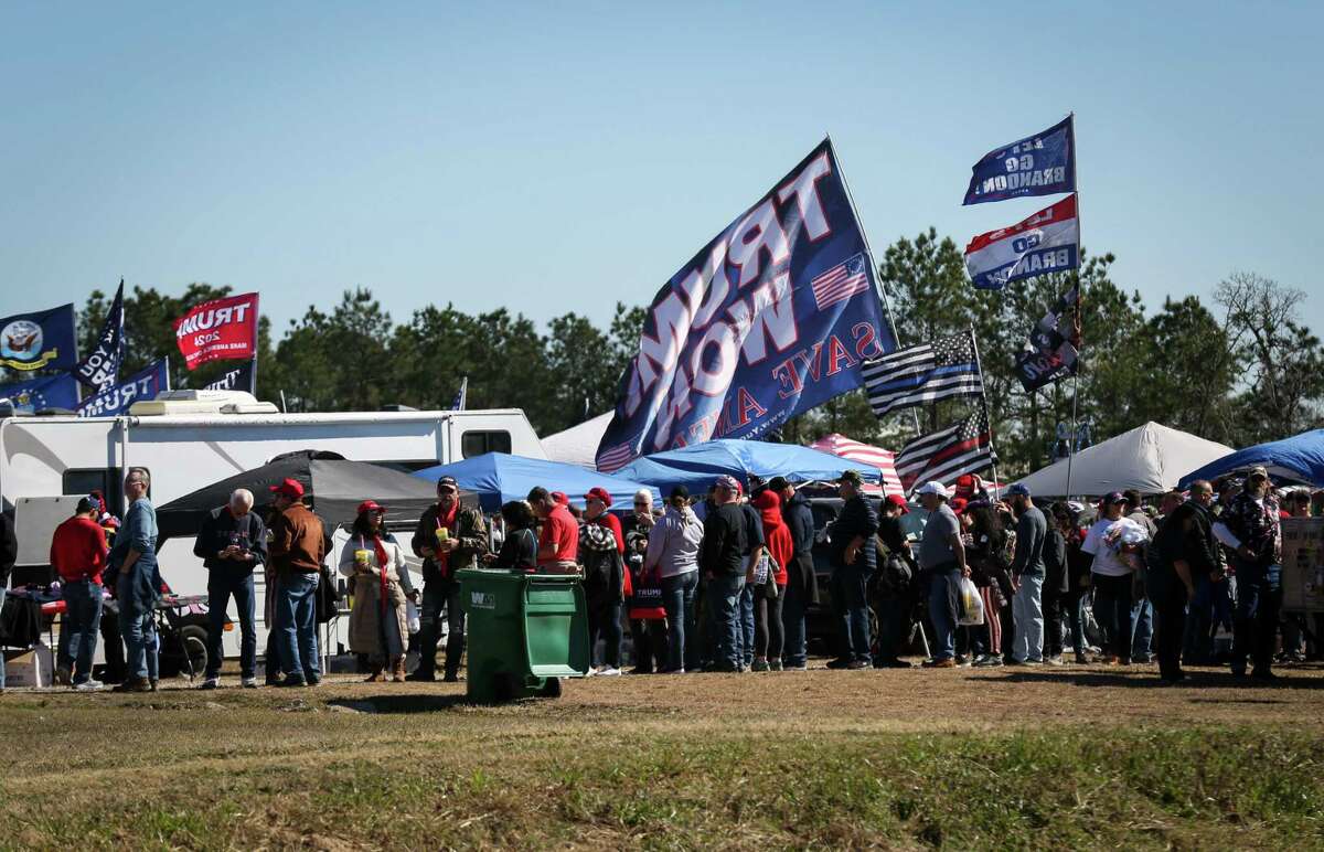 People wait to go through security before a Save America rally with former President Donald Trump on Saturday, Jan. 29, 2022, at the Montgomery County Fairgrounds in Conroe.