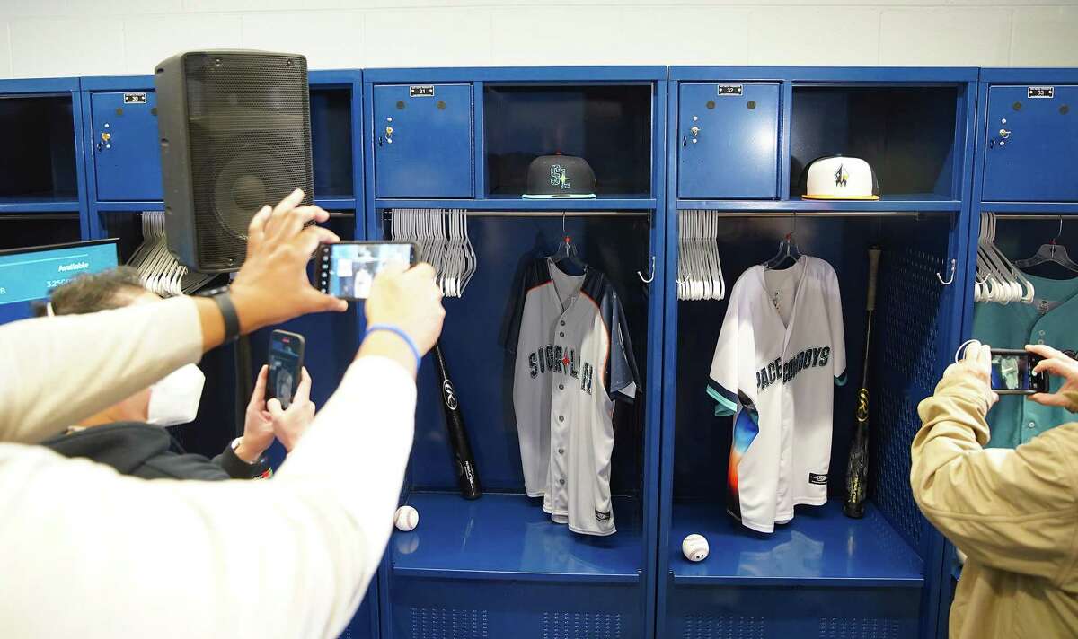 Media takes photos of the new uniforms for the Sugar Land Space Cowboys before a press conference announcing the team name and mascot on Saturday, Jan. 29, 2022 in Sugar Land .