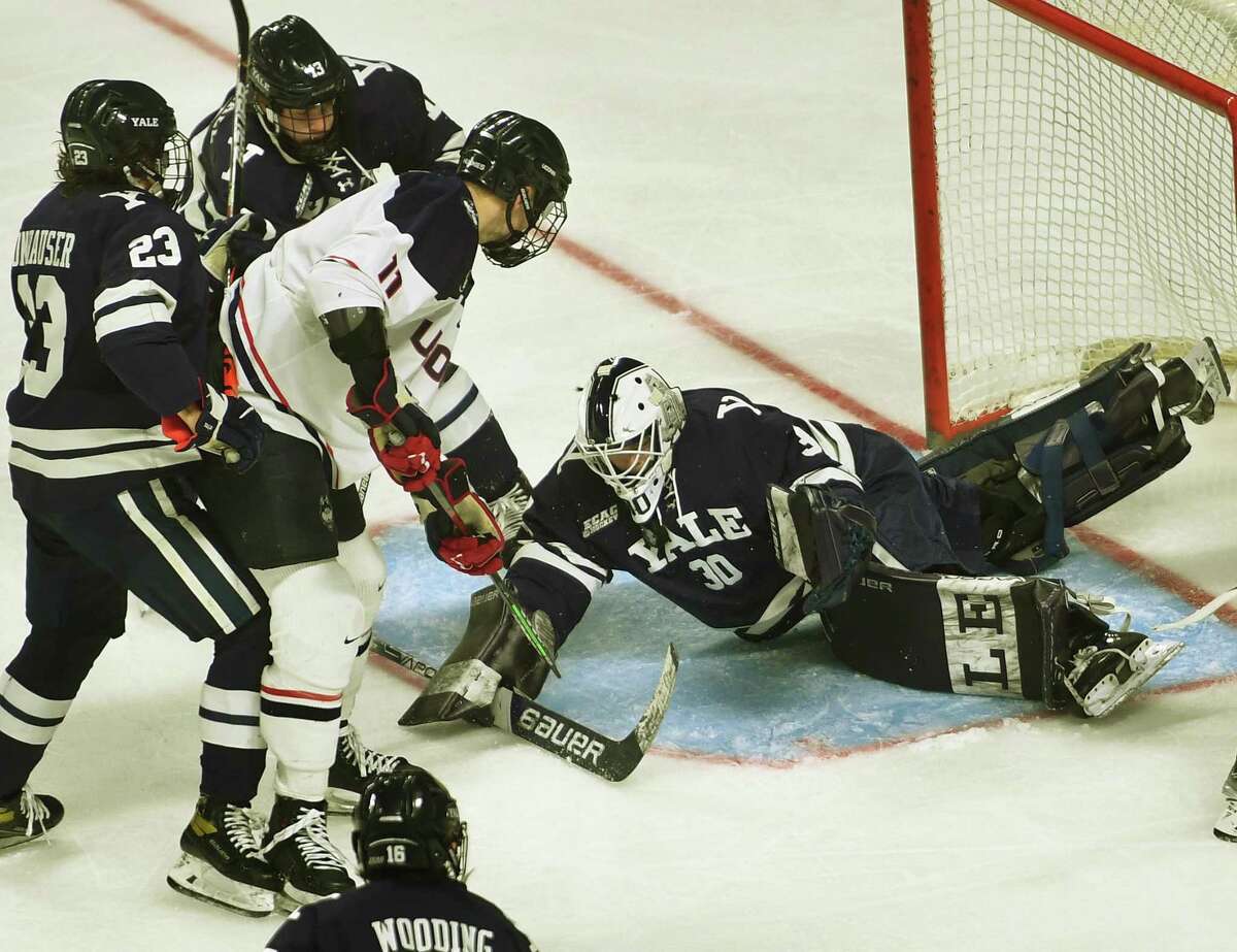 Yale goalie Luke Pearson makes a sprawling save on a shot by UConn’s Jachym Kondelik during the third period of the Huskies’ victory in the opening round of the Connecticut Ice tournament Saturday at Webster Bank Arena in Bridgeport.