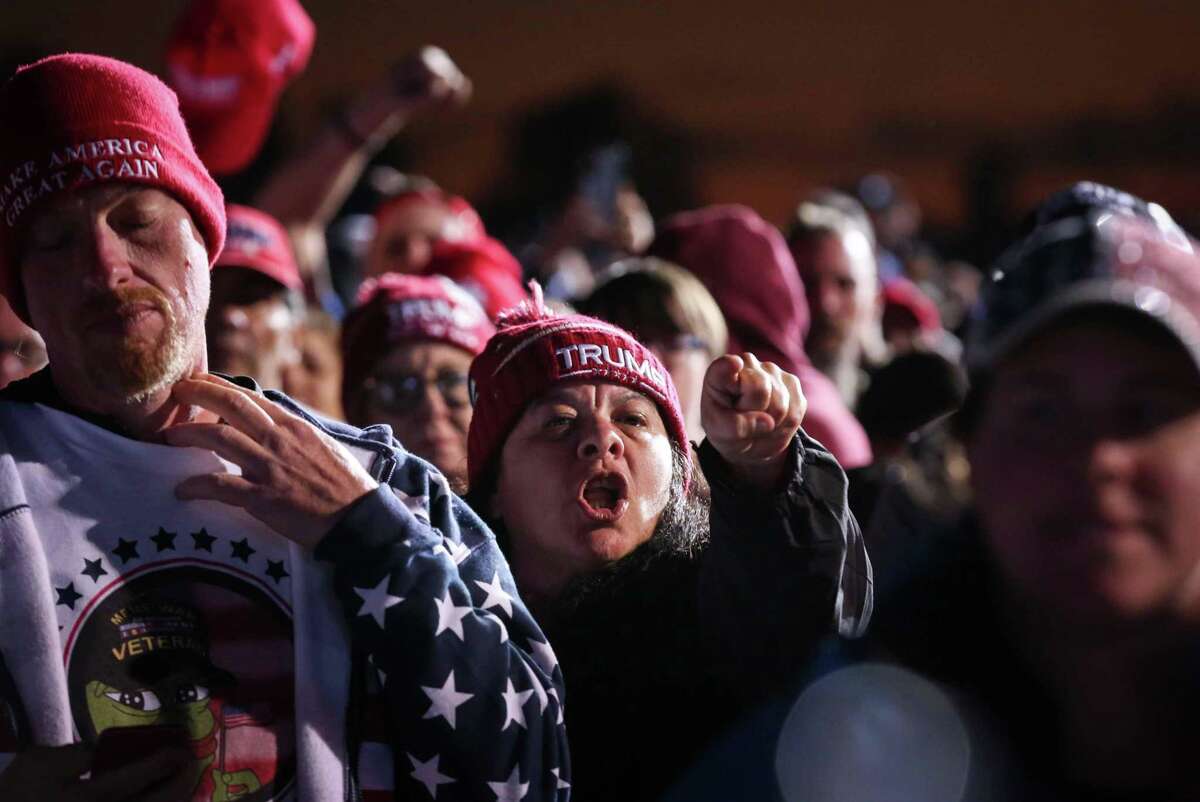 A woman yells at Gov. Gregg Abbott during a Save America rally with former President Donald Trump on Saturday, Jan. 29, 2022, at the Montgomery County Fairgrounds in Conroe.