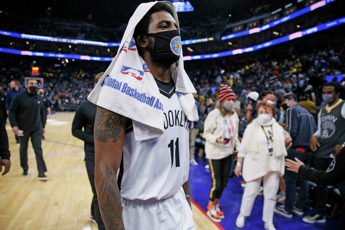 Brooklyn Nets guard Kyrie Irving (11) walks to the locker room for halftime during an NBA game against the Golden State Warriors at Chase Center, Saturday, Jan. 29, 2022, in San Francisco, Calif.