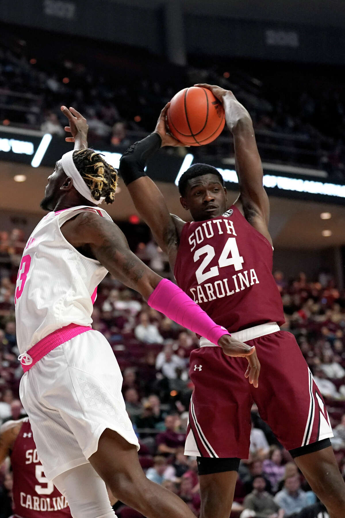 South Carolina forward Keyshawn Bryant (24) grabs a rebound over Texas A&M guard Quenton Jackson (3) during the first half of an NCAA college basketball game Saturday, Jan. 29, 2022, in College Station, Texas. (AP Photo/Sam Craft)