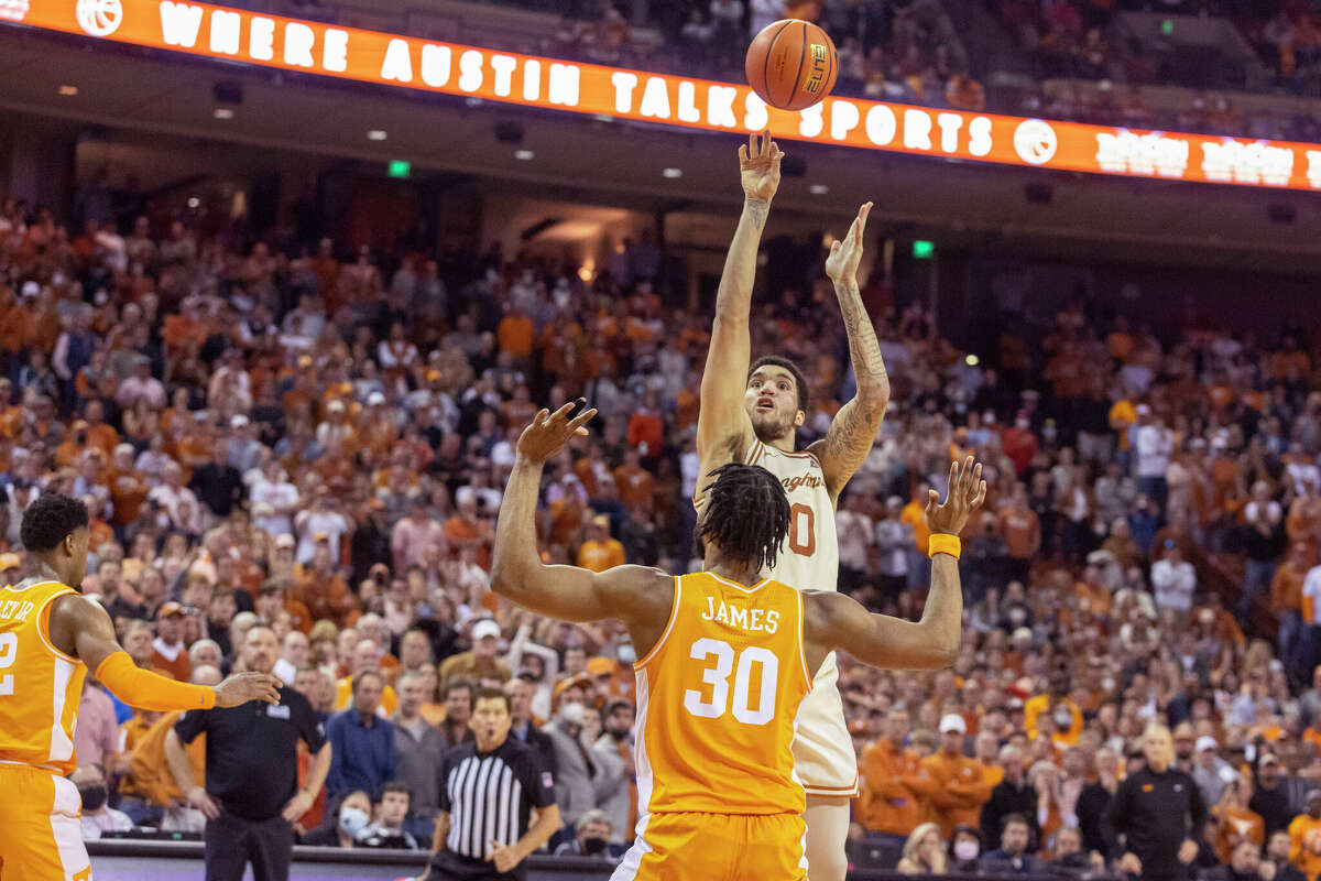 Texas forward Timmy Allen (0) shoots over Tennessee guard Josiah-Jordan James (30) in the final moments of the second half of an NCAA college basketball game Saturday, Jan., 29, 2022, in Austin, Texas. (AP Photo/Stephen Spillman)