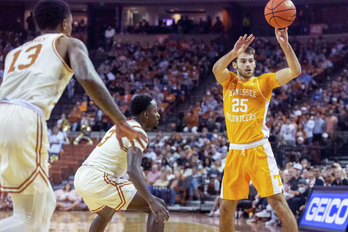 Tennessee guard Santiago Vescovi (25) passes the ball away from Texas guards Courtney Ramey (3) and Jase Febres (13) during an NCAA college basketball game Saturday, Jan., 29, 2022, in Austin, Texas. (AP Photo/Stephen Spillman)