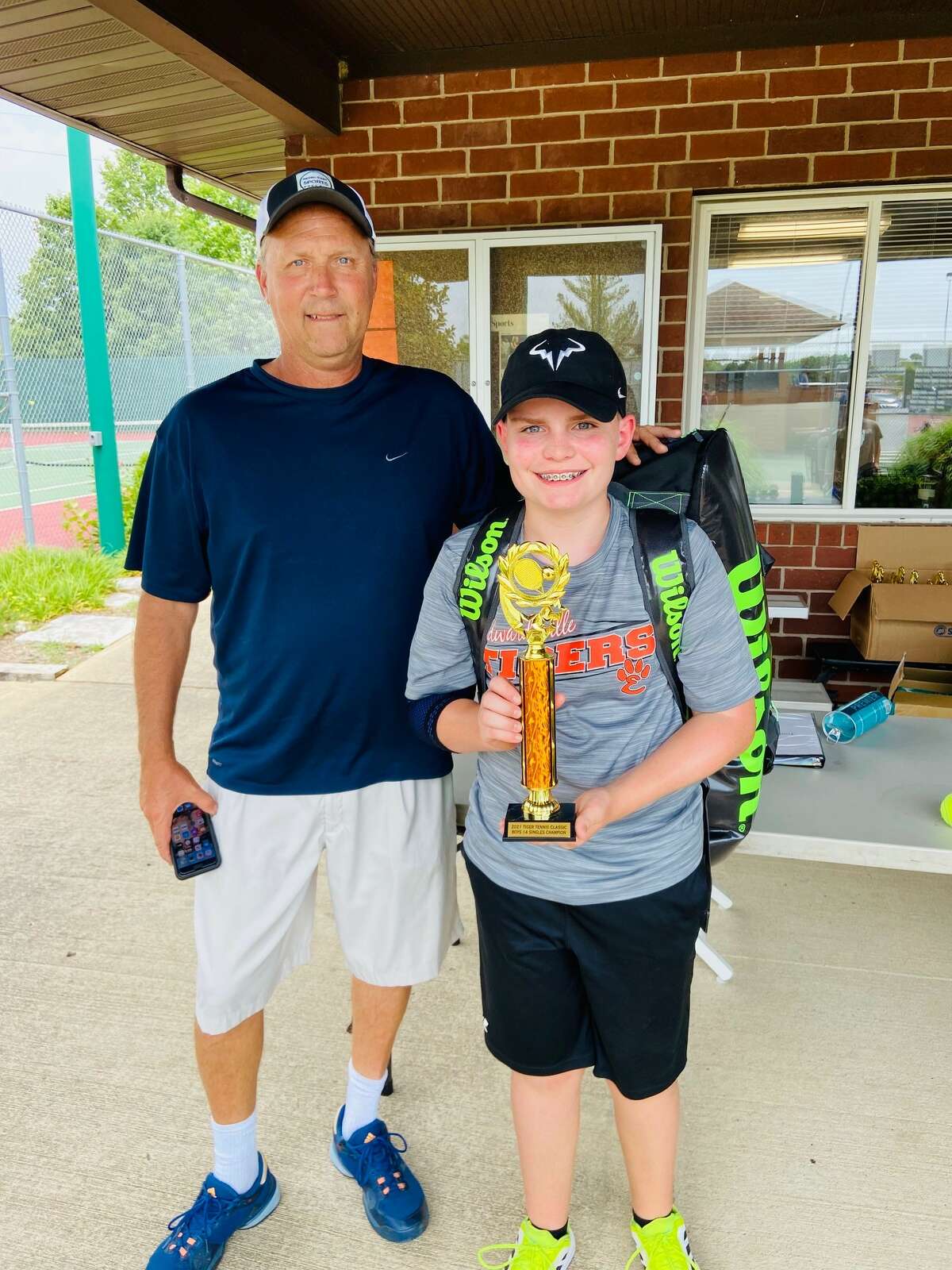 EHS tennis coach David Lipe (left) with Schaefer Bates (right) at the Tiger Classic, where Bates was the singles champion in the under 14 boys age group. 