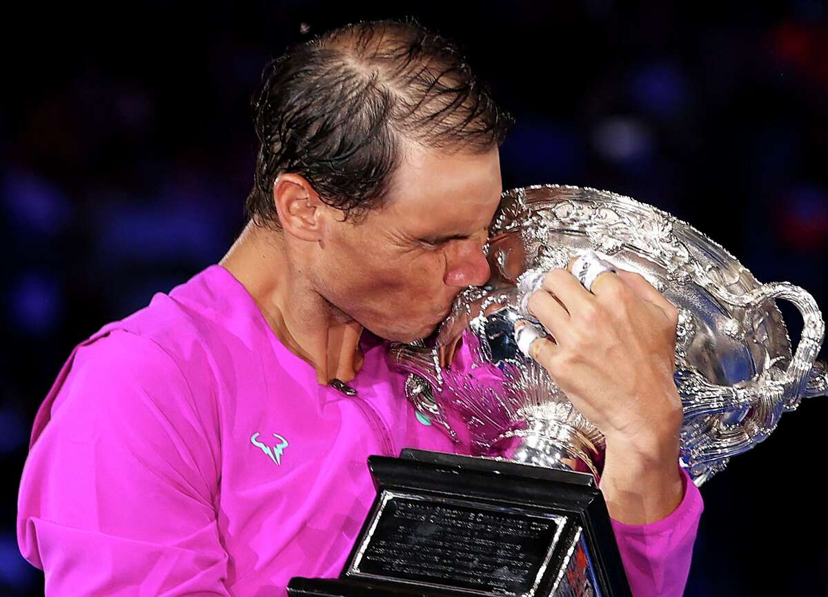 Rafael Nadal of Spain kisses the Norman Brookes Challenge Cup as he celebrates his men’s singles final victory over Daniil Medvedev of Russia at the Australian Open in Melbourne.